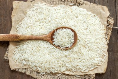 basmati-rice-with-spoon-brown-wooden-table_202769-1517